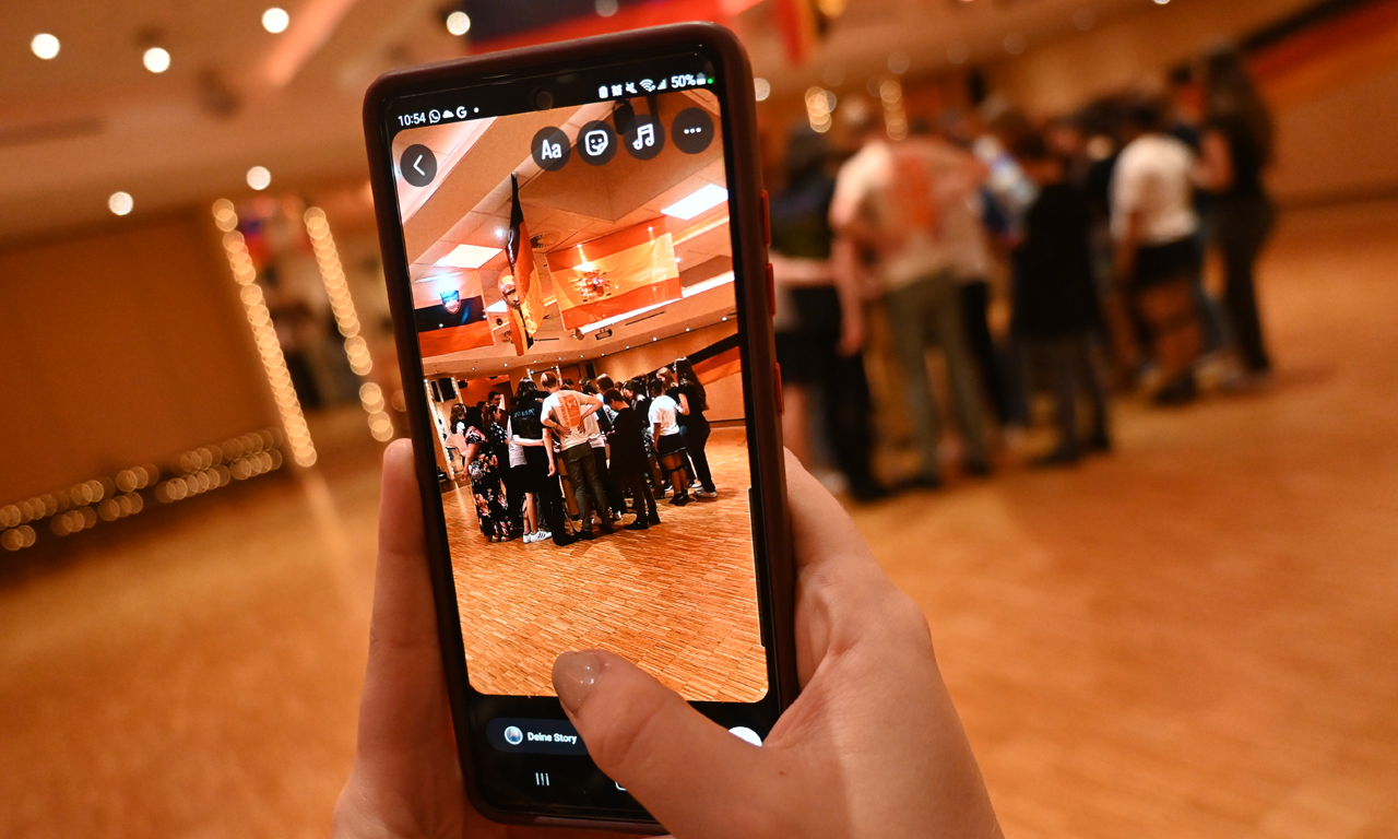 Gutscheinbox Tanzschule Stüwe-Weissenberg Bild von Tanzgruppe auf einem Smartphone